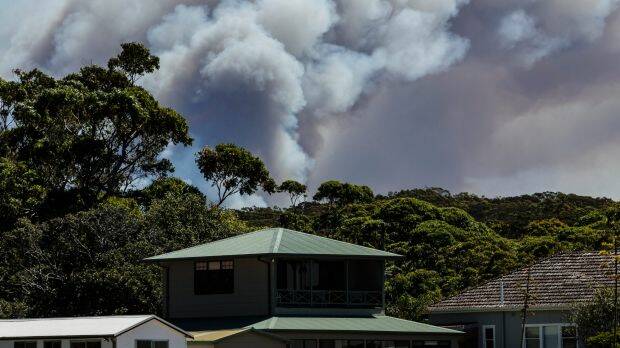 An out-of-control bushfire burning in the Royal National Park, as seen from Bundeena. Photo: Brook Mitchell