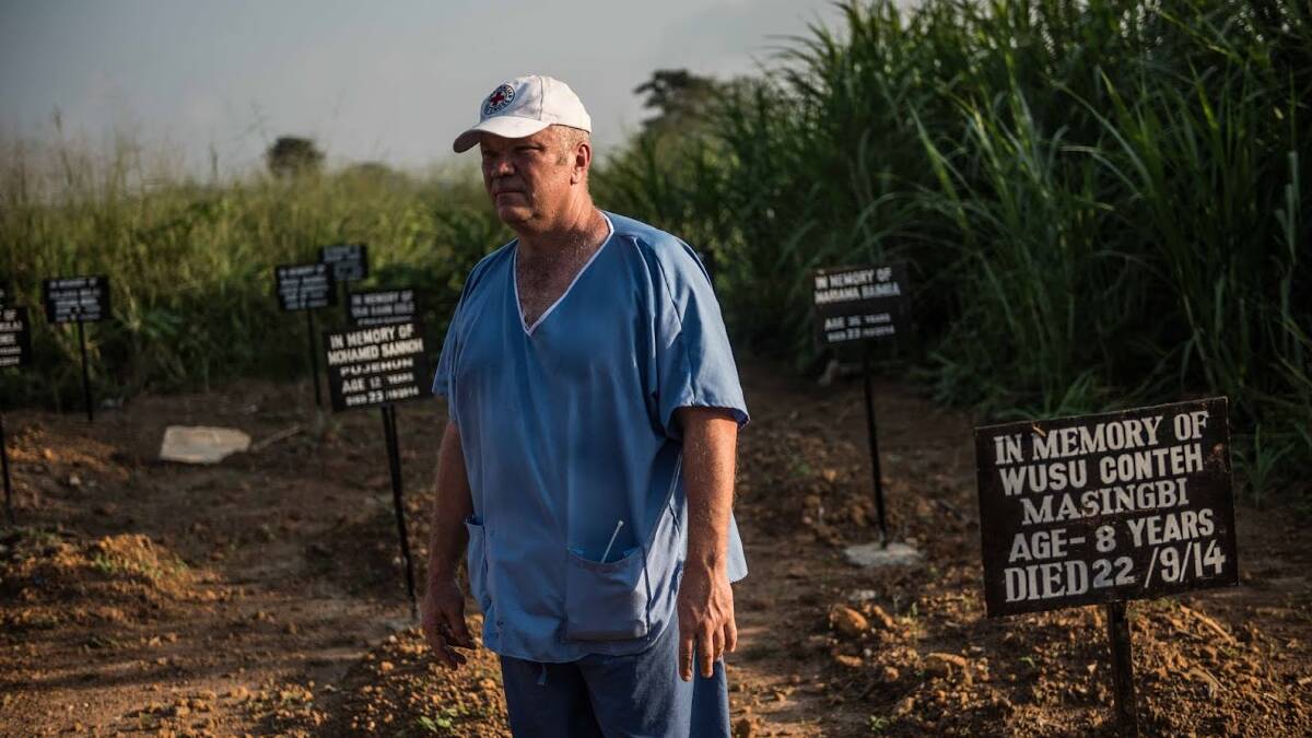 Joel Donkin stands among grave sites at the Ebola treatment centre. Photo: Red Cross.