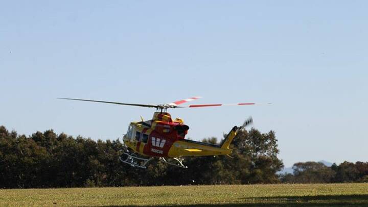 The Westpac Rescue Helicopter lands at Old Bar this morning. Photo: Shane Woodhouse.