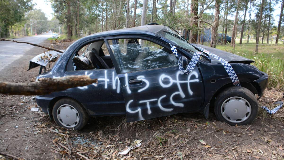 The message scrawled on the side of the car wreck on the Bucketts Way.