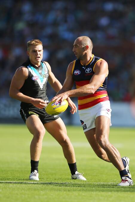 James Podsiadly of the Crows gets away from Ollie Wines of the Power during the Showdown on Saturday. Photos: Getty