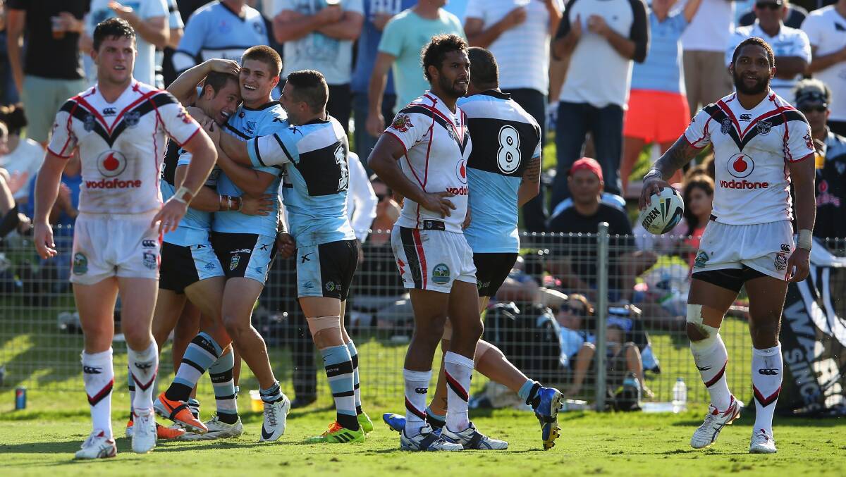 Nathan Stapleton of the Sharks celebrates with Blake Ayshford and Michael Gordon of the Sharks after scoring a try. The Sharks trounced the Warriors 37-6 to record their first win for the season. Picture: Getty Images
