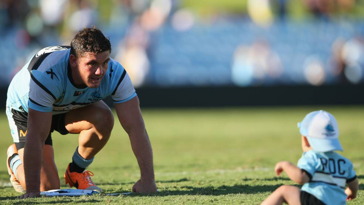 Chris Heighington of the Sharks plays with his son Rocco on field after the match. The Sharks trounced the Warriors 37-6 to record their first win for the season. Picture: Getty Images