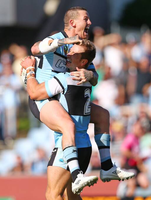 Nathan Stapleton of the Sharks celebrates his 4th try with team mate Todd Carney. The Sharks trounced the Warriors 37-6 to record their first win for the season. Picture: Getty Images