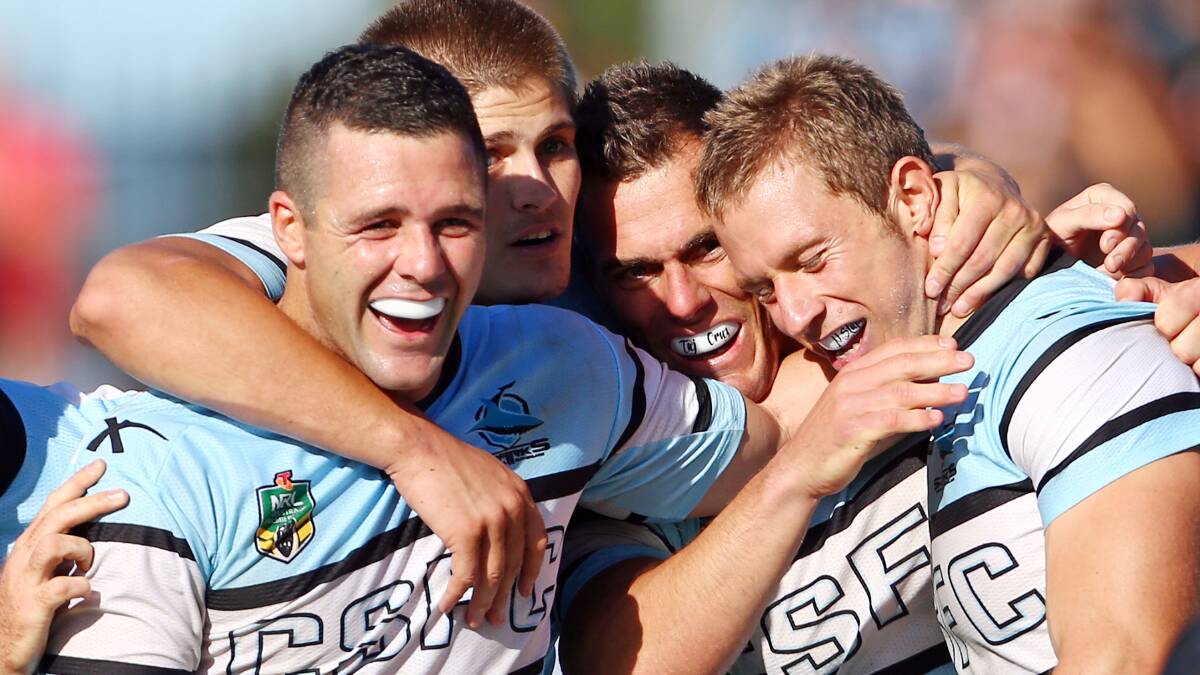 Michael Gordon, Blake Ayshford, John Morris and Nathan Stapleton celebrate. The Sharks trounced the Warriors 37-6 to record their first win for the season. Picture: Getty Images