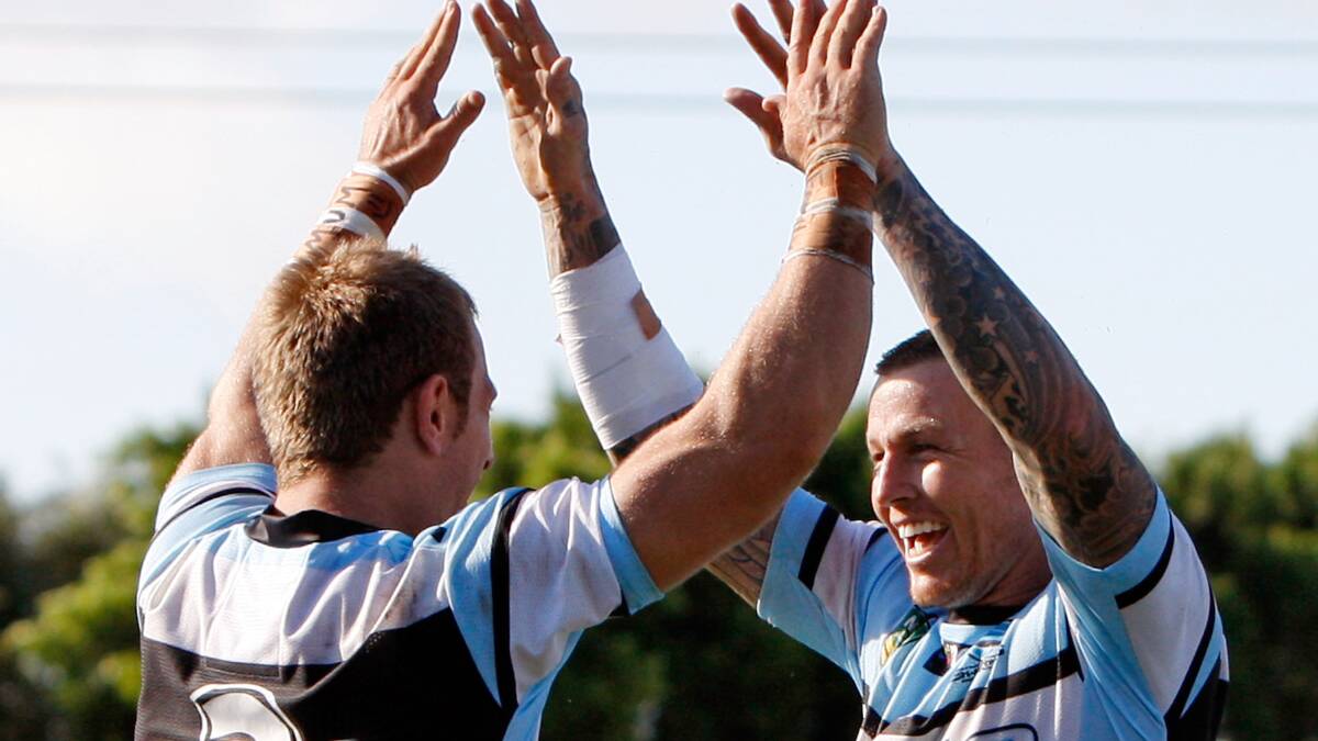 Nathan Stapleton of the Sharks celebrates his third try with team mate Todd Carney. The Sharks trounced the Warriors 37-6 to record their first win for the season. Picture: Getty Images