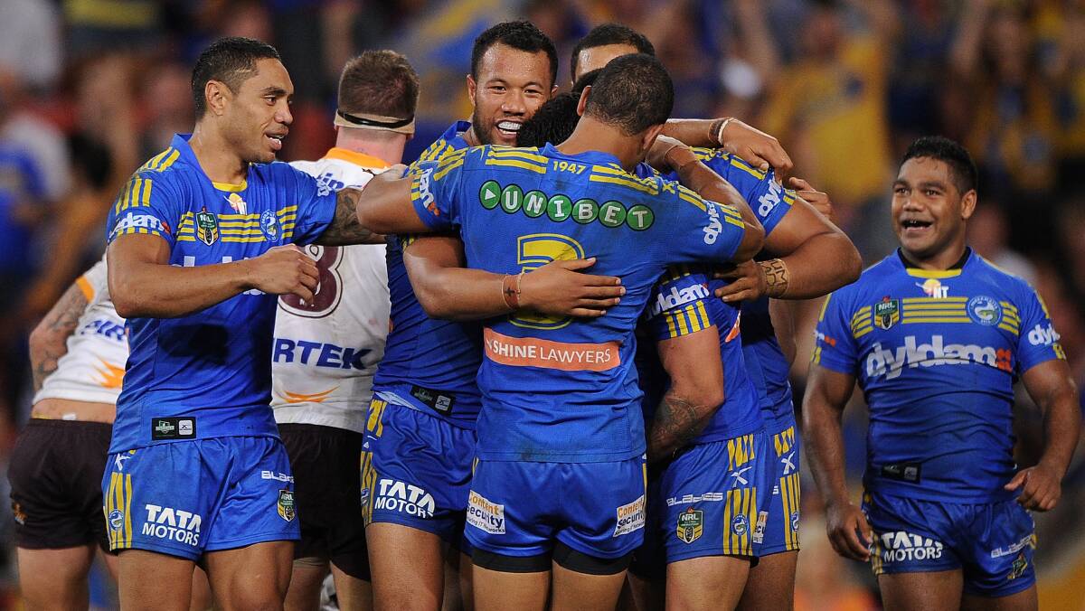 Nathan Peats (obscured) of the Eels celebrates scoring a try with team-mates. The Eels defeated the Broncos 25-18 on Brisbane turf in Round Five of the NRL. Picture: Getty Images