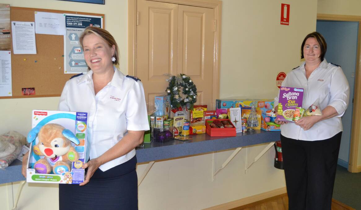 TOYS, FOOD AND LOVE: Salvation Army envoys Leica Lauder and Melissa Gilles with some of the goods donated so far for their Christmas appeal.