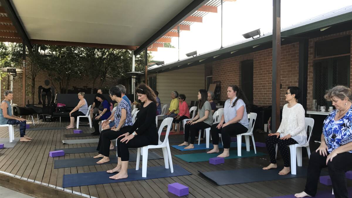 Carers enjoyed yoga on the back deck of the gallery.