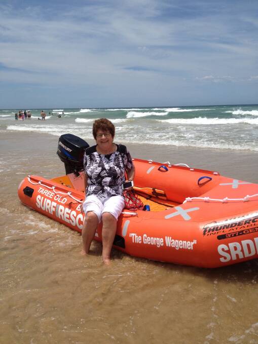 Honoured: Gay Wagener with the new Taree Old Bar Surf Live Saving Club surf boat named after her husband George. Photo: Judy Muscio.