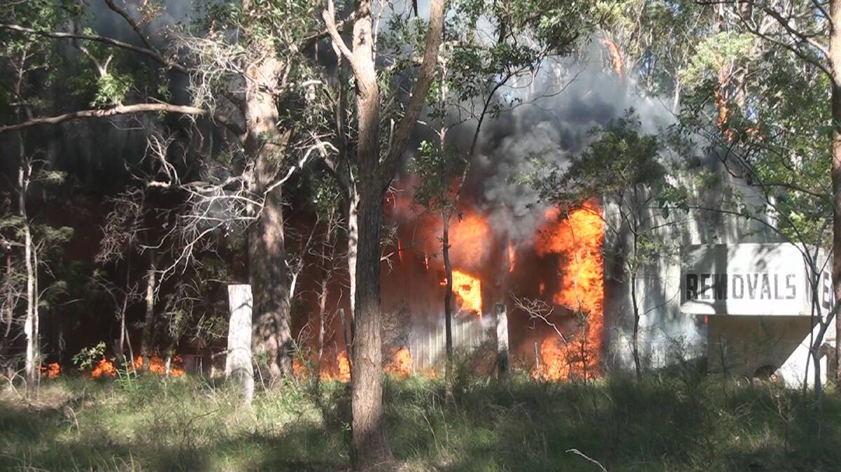 Fire crews attended to a fire at Pampoolah on Monday, August 8. A storage shed and two hectares of grass were burnt through. Photo: David Carroll.