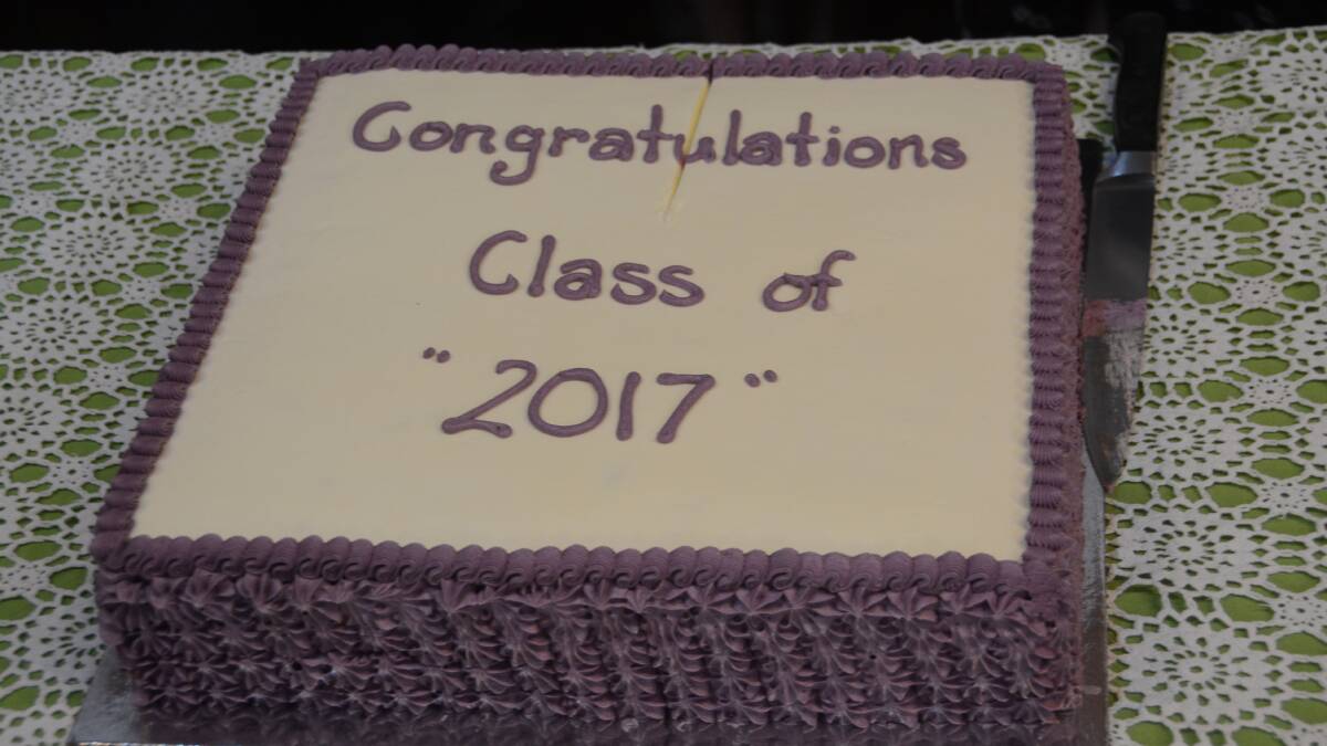 The students celebrated their graduation with a cake.