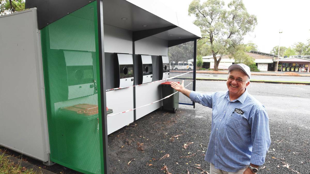 Put to good use: Old Bar Tavern's Mark O'Neill with the reverse vending machine. Photo: Scott Calvin. 