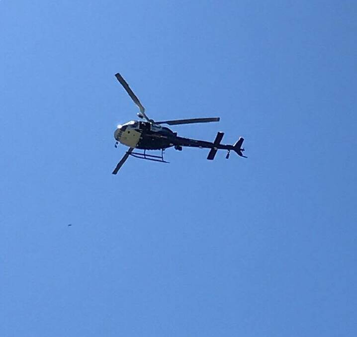 A police helicopter flies over Cundletown in search of Ms Dean. Photo: Daniel Douglas.