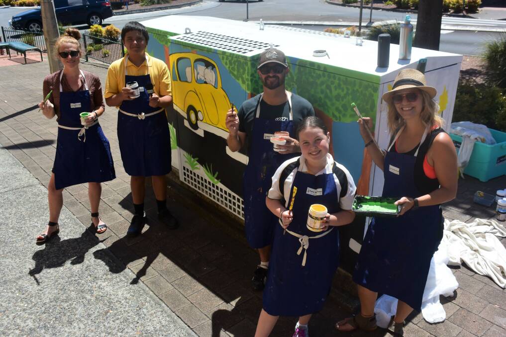 Brightening up the streets: Taree High School's Laura Southwell, Fernando Teggatz, House With No Steps' Jon Vine, Courtney Stace and Aimee Pelley from Paint Your Town Manning Valley/ Great Lakes adding the colourful design to the padmount. Photo: Rob Douglas. 