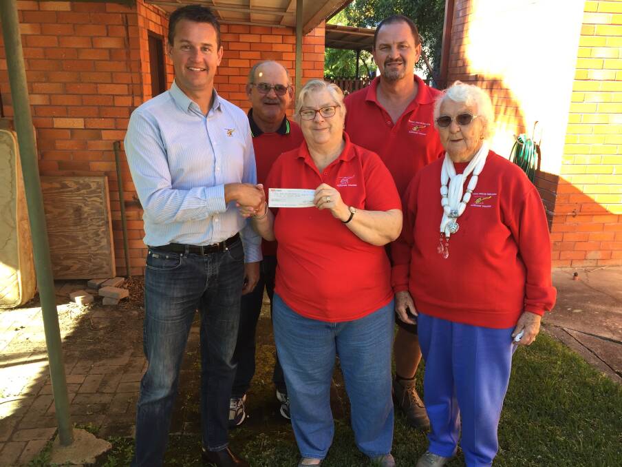Saving lives: Westpac Rescue Helicopter regional marketing manager Chad Griffith received the donation from Taree support group volunteers. Photo: Rob Douglas. 