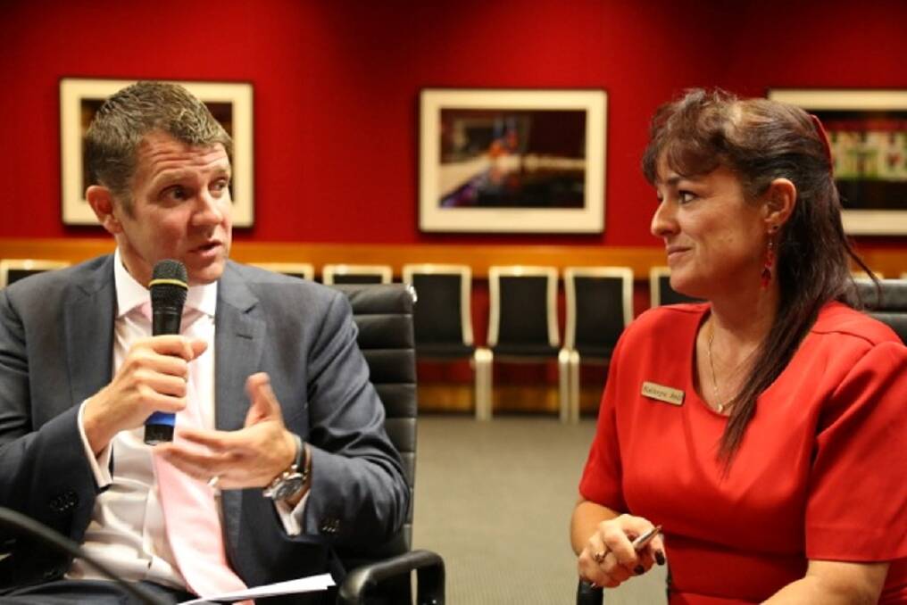 Right: Mike Baird discusses a point with Kathryn Bell.