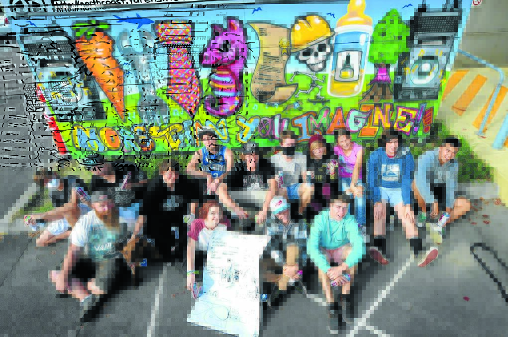 A work of art: Ash Johnston (front left), TAFE therapy dog Juno and this week's graffiti workshop participants John Wood, Ben Cross, Tim Hendricks, Mikayla Richards, Jose Dean, Harrison Schuber, Rache Gillies, Bronson Morris, Arki Murphy, Jay Smith, Jessica Jose, Daniel Argall and James Tubner with the mural they created.