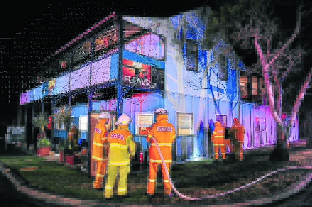 Rural fire fighters on the scene at Flow Espresso Bar, shortly after a fire was extinguished by the driver of a courtesy bus. Julie Slavin photo.