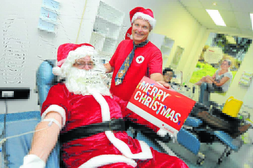 Rolling up their sleeves to save lives: Santa, Greg French and Hyoun Jung Choi at the Taree Blood Bank.