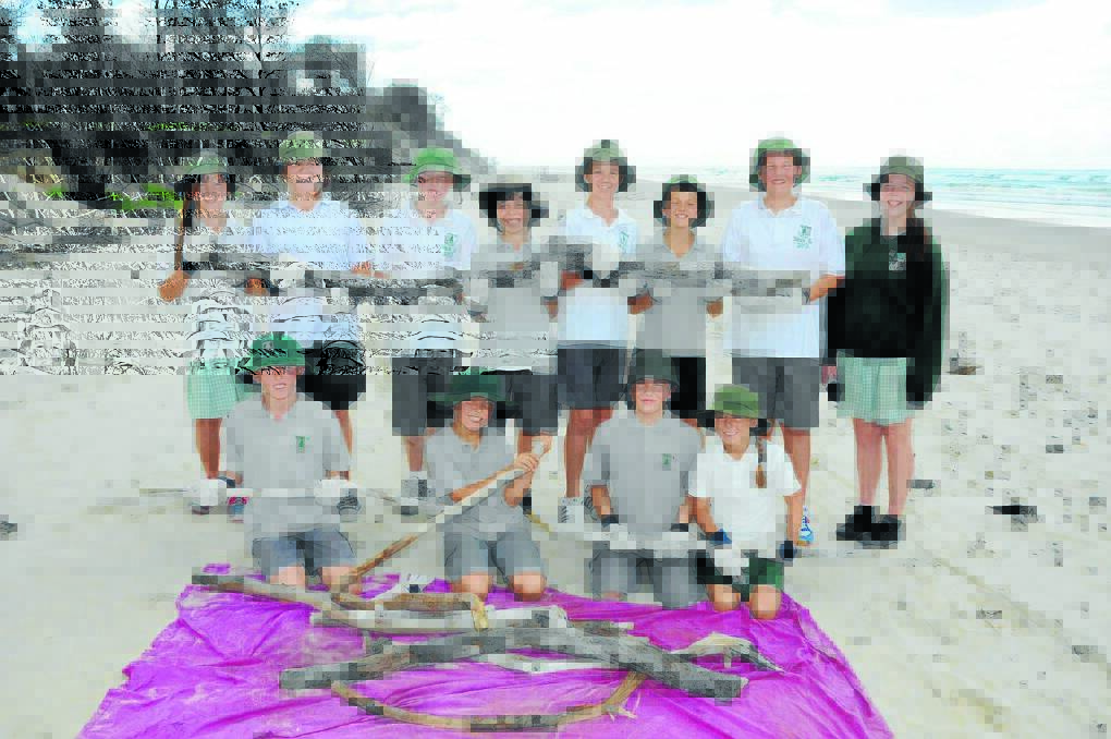 Old Bar Public School students proudly hold a selection of some of the driftwood they collected at Old Bar Beach. Back row: Valentina Timoshenko, Tiffany Woollard, Dylan McLennan, Brendan Armstrong, Josh Shoesmith, Troy Woodward, Jaiden Ellis and Shanae Carroll. Front row: Max McKillop-Davies, Tyson Thorpe, Hayden Jones and Jemma Hatton.