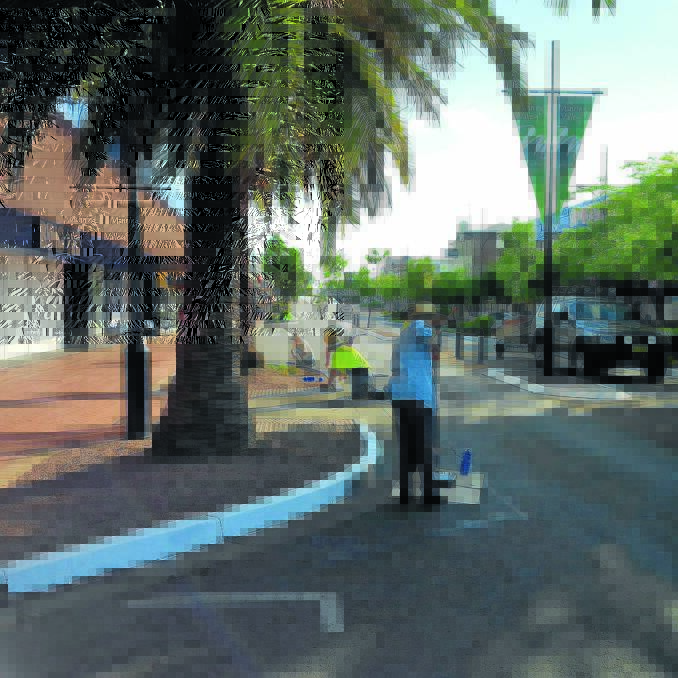 Tidy Up Taree volunteers at work in Victoria Street very early on Saturday morning.