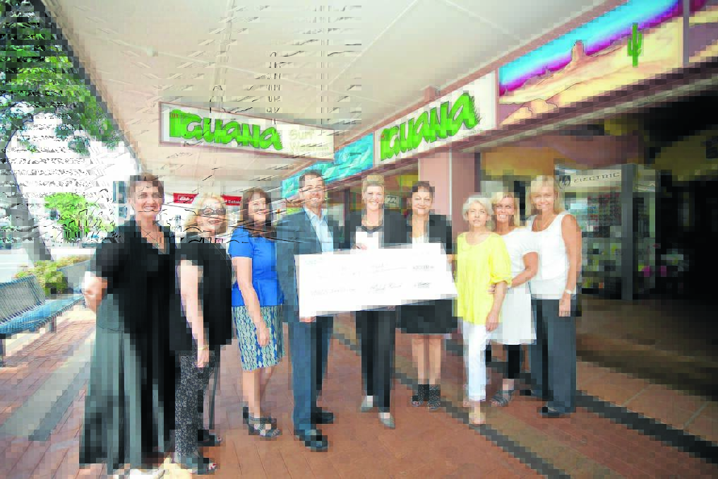 Some of the Can Assist Manning Valley team Sharon Smyth, Dyana Brown, Leanne Newman, Melinda Allan, Bonita Lindfield, Sue Pitman and Lee Walters accepting the cheque from Michael Yarad and Jo-Anne Cumming of Yarads and Iguana.