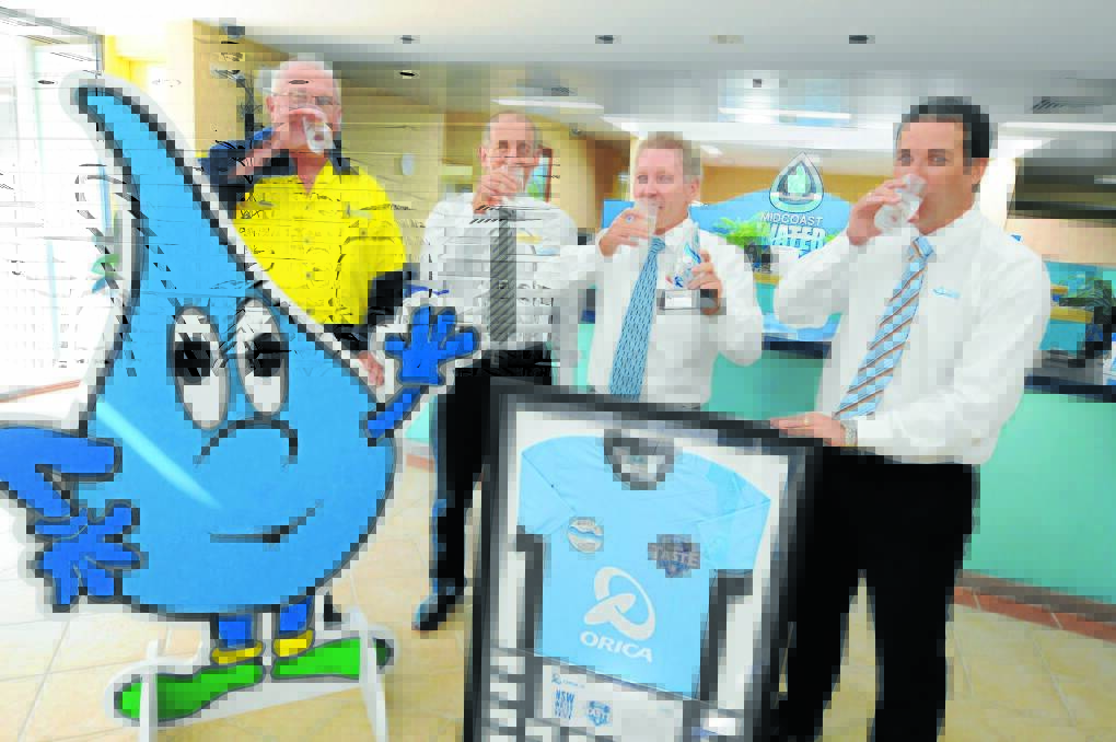 Cheers to a good year: MidCoast Water’s Bootawa water treatment plant operator Geoff Kerr, MidCoast County Council chairman Aled Hoggett, general manager Robert Loadsman and executive manager of infrastructure development, Brendan Guiney toast the county council’s win in the inaugural ­State water taste test.