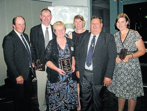Statewide honour: President of the Agricultural Societies Council of New South Wales, Geoff Bush (left) presents the society's 'outstanding contribution' award to the Weller family of Nabiac, Val and Selwyn (front) and their children Murray, Penni and Kim, at a ceremony in Sydney.