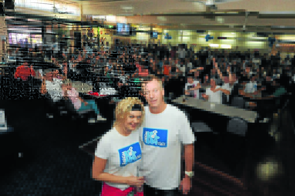 Kristylea Bridge with her dad Gary and the crowd who turned out to support her at Taree Railway Bowling Club on Sunday. Kristylea has returned to Sydney for more cancer treatment.