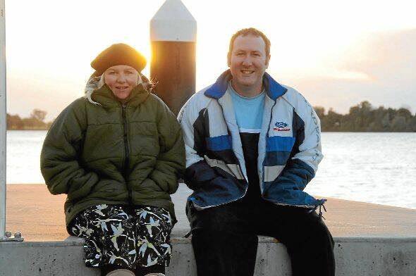 Sarah Pieschel and Darren Golding from Job Find complete their night of sleeping rough as dawn breaks over the Manning River.