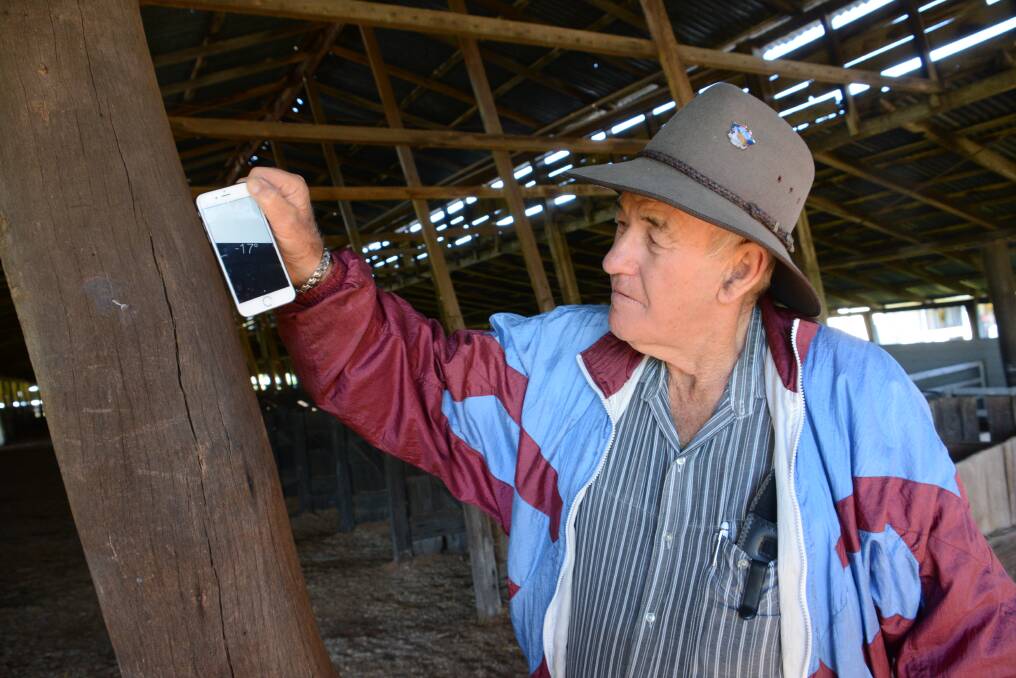 Allan Richards uses an Iphone to show the building's lean. 
