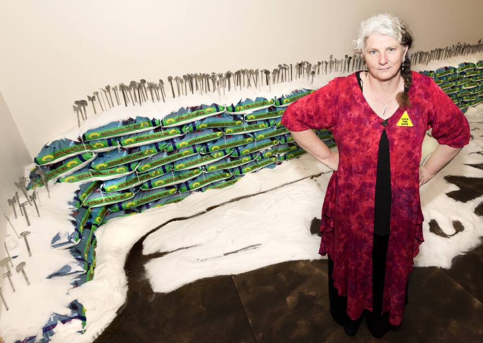 Trish Preston with three tonnes of pool salt that features in her exhibition. Ashley Cleaver photo.