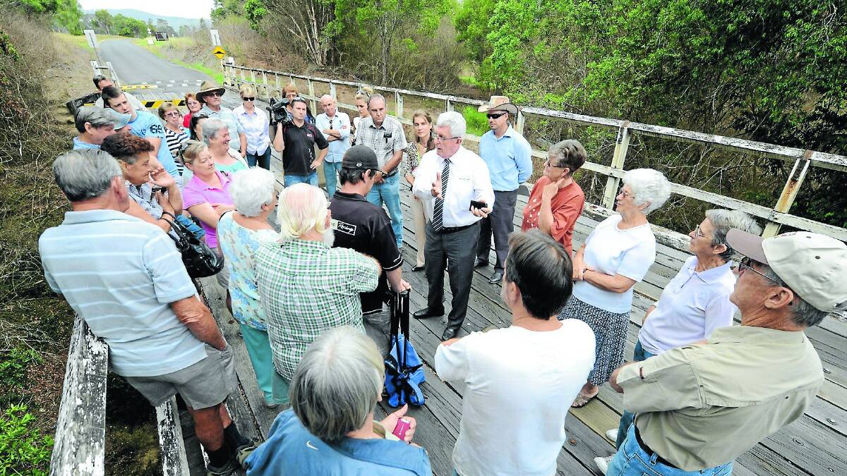 Greater Taree City Council mayor Paul Hogan (centre) rallies residents of the Dyers Crossing community to fight the federal government decision to withdraw its funding of the Greater Taree Roads and Bridges Package.
