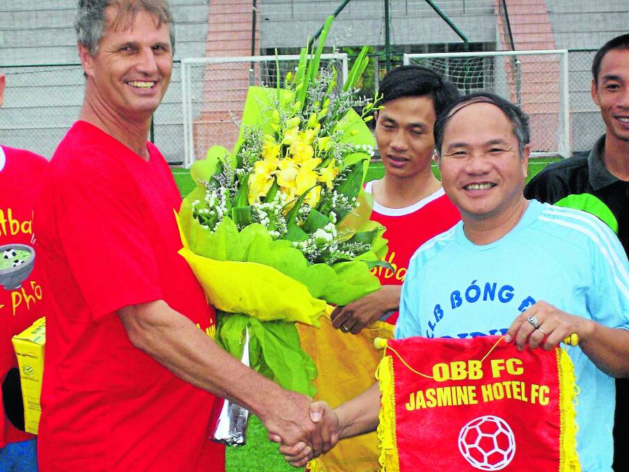 Old Bar over 35s captain Lance Sharp presents a banner to Hanoi opponents during the club's 2010 tour. The Barbarians will be raising funds for a charity group in Cambodia before returning to the region in 2015.