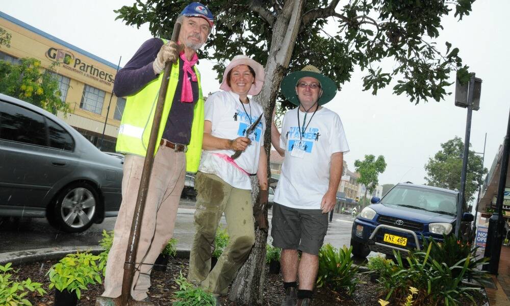Rain didn't dampen their enthusiasm: Ted Hunt, gardening guru Meredith Kirton and Tidy Up Taree organiser, Graham Brown.