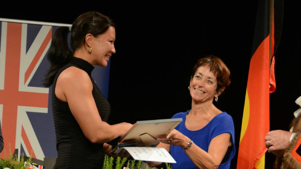 Arlene Blencowe accepts the Ken McDonald Memorial Sportstar of the Year award from Toni Fatherley, Ken McDonald's youngest daughter, at the Australia Day awards held at the Manning Entertainment Centre.
