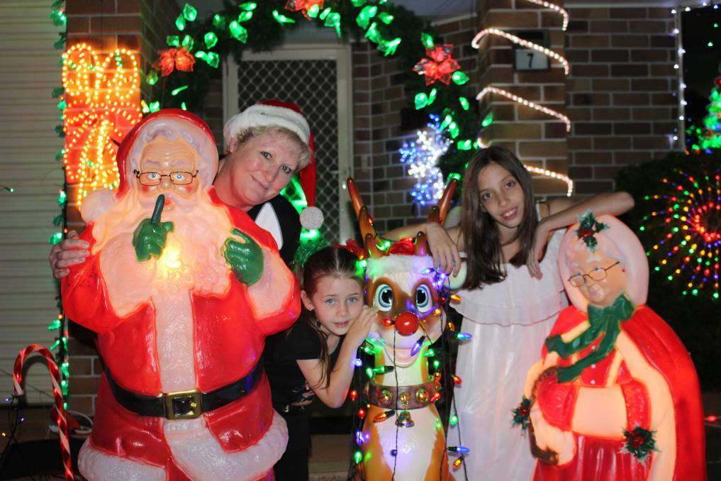 VICTORIA POINT: Ros Barton outside her Christmas lights display at Carlyle Court, Wellington Piont with grand daughters Milahnee Chapman, 11, and Addisyn Chapman, 5, both of Victoria Point.