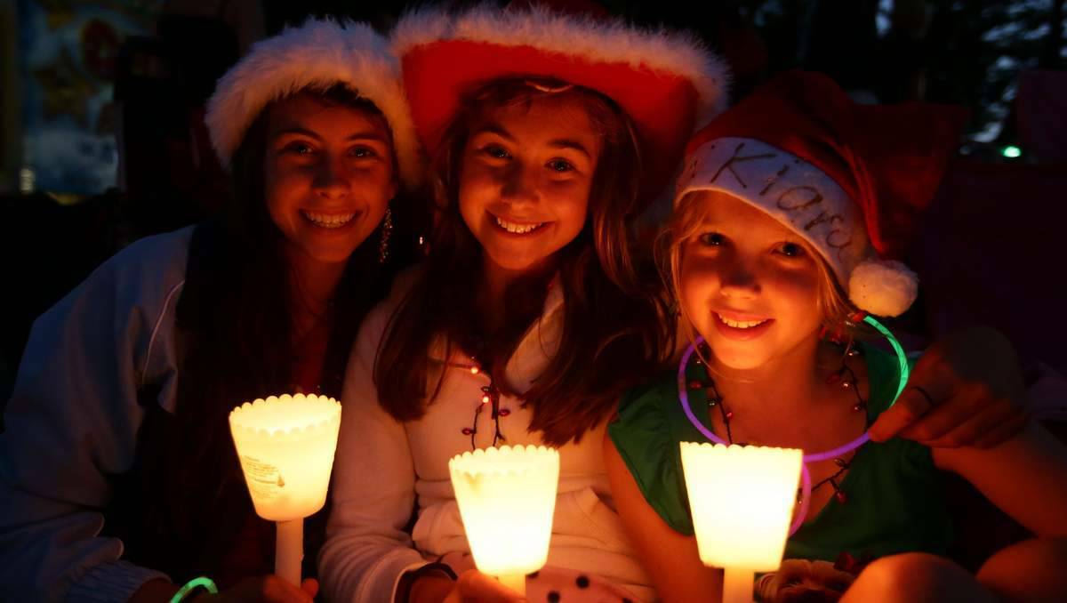 NEWCASTLE: Scenes from Carols by Candlelight in King Edward Park on Friday. Sisters Monique Bower, 15, Lateisha Bower, 13, and Kiara Bower, 9,of Marks Point. Picture: Peter Stoop