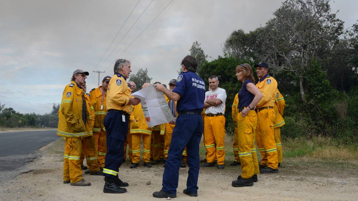 Firies are updated on the situation in Crowdy Bay National Park. Pic: Carl Muxlow