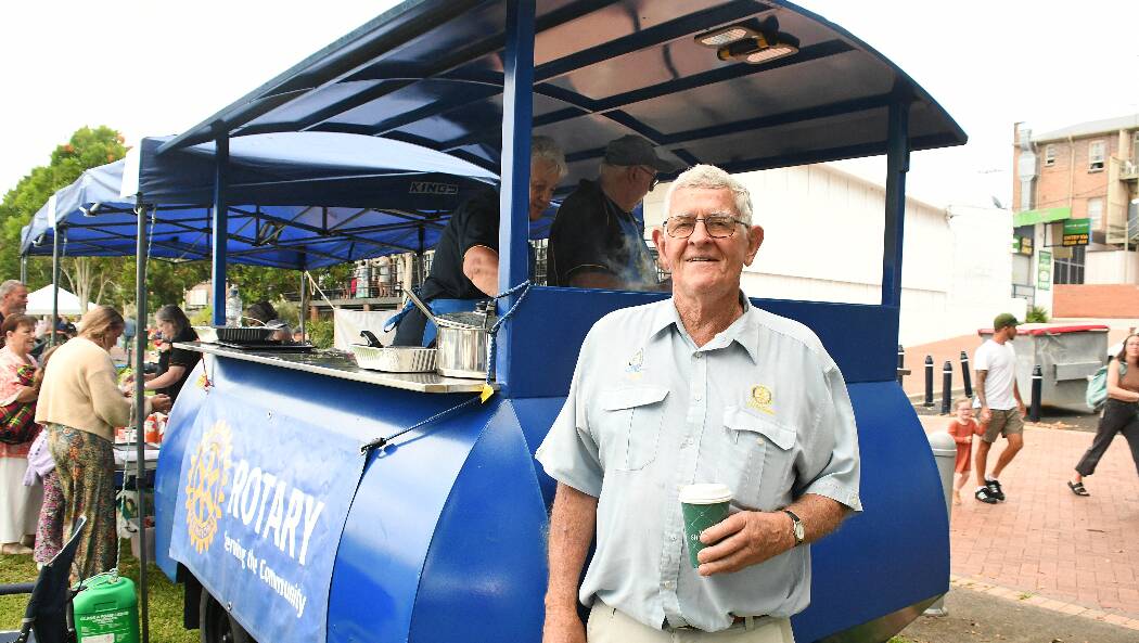 Paul Tollis from the Rotary Club of Taree On Manning standing proudly by the barbecue van on New Year's Eve. Picture by Scott Calvin. 