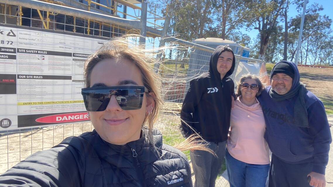 ACM reporter Alanna Tomazin, 24, with her brother Nicolas, mother Annmarie, and father Mitch when she and Nicolas bought and built a family home in the NSW Hunter region. Picture: Supplied