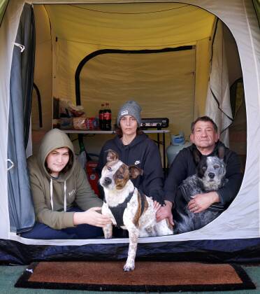 Disability support worker Julieann Bailey, husband Richard, son Dylan, 16, and their two dogs Gizmo and Patch live in a tent at Country Capital Caravan Park just outside Canberra in Sutton, NSW. Picture: Lanie Tindale
