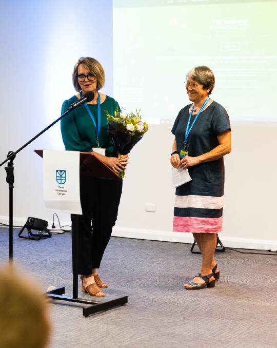 Taree Universities Campus CEO Donna Ballard presenting flowers to TUC chair Dr Alison McIntosh at the university's first birthday. Photo: Jake Davey 