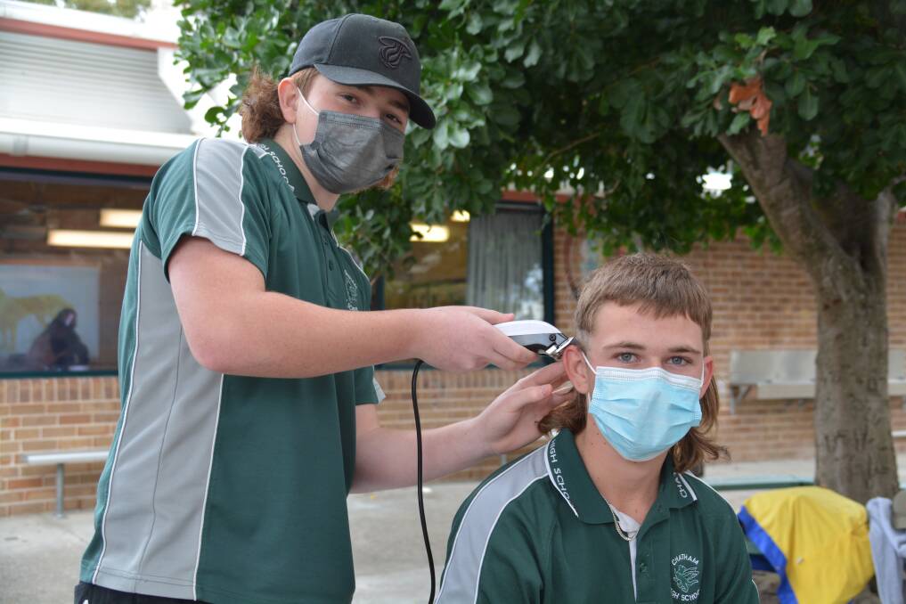 The team raised almost $500 for mental health research. Pictured is Linkin Mawson touching up Colby Gill's mullet. 