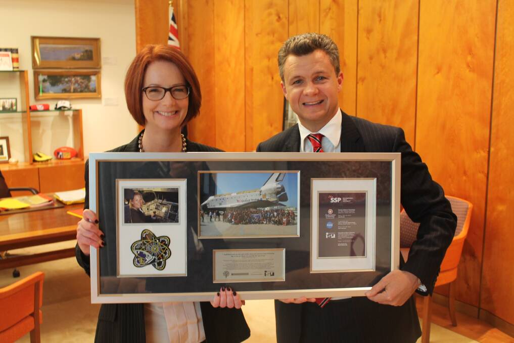 Former prime minister Julia Gillard and senator Matt Thistlethwaite holding the presentation Kim Ellis gave Julia to thank her personally for her support.