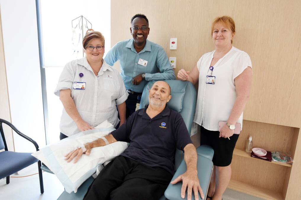Manning Hospital's nursing unit manager Donna Nicholson, clinical services director Osama Ali and general manager Jodie Nieass with the first cancer patient to use the hospital's new oncology treatment bays, Keith Bradshaw.