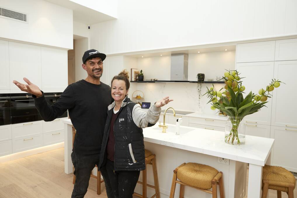Tired but excited: Andy and Deb Saunders in their winning kitchen, which features an eye-catching three-storey void to a skylight that lets in natural light.