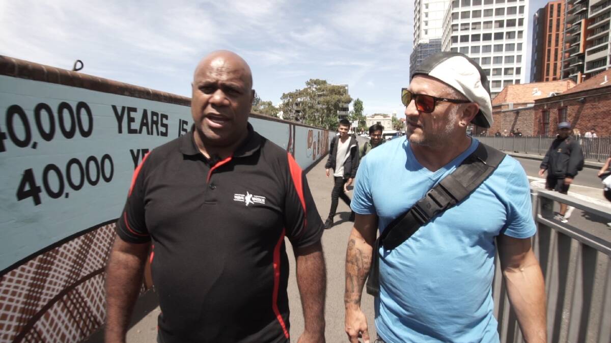 Grant Saunders talking with community leader Shane Phillips about Redfern Uprising. Photo courtesy Grant Saunders.