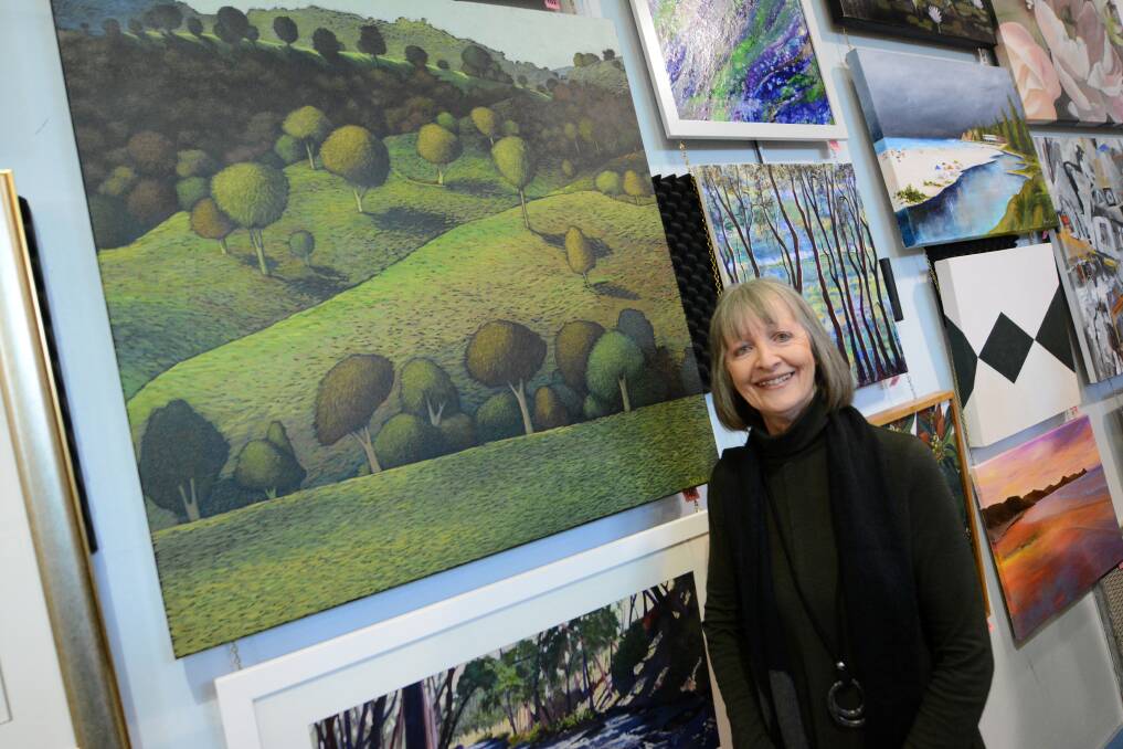Taree Open Art Exhibition: Yvette Hugill with her work Silhouettes, which won second prize in the Works on Board and Canvas open section. The exhibition, at Taree High Hall, continues until Sunday. Photo: Scott Calvin.